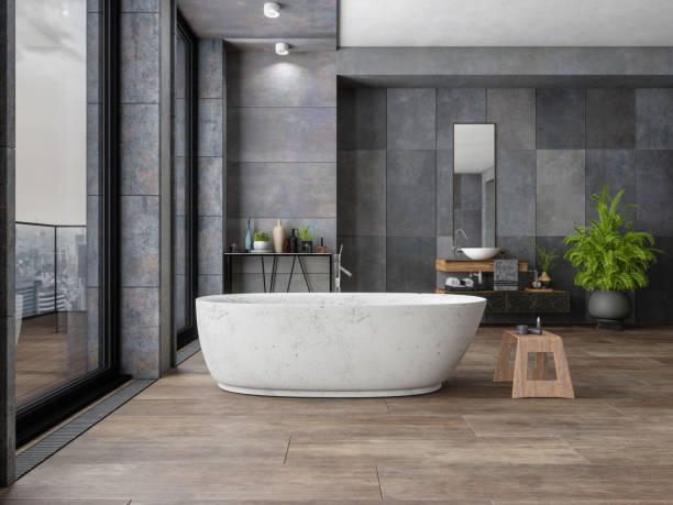 Modern bathroom with dark flooring, gray walls, and a bathtub | All Floors Design Centre