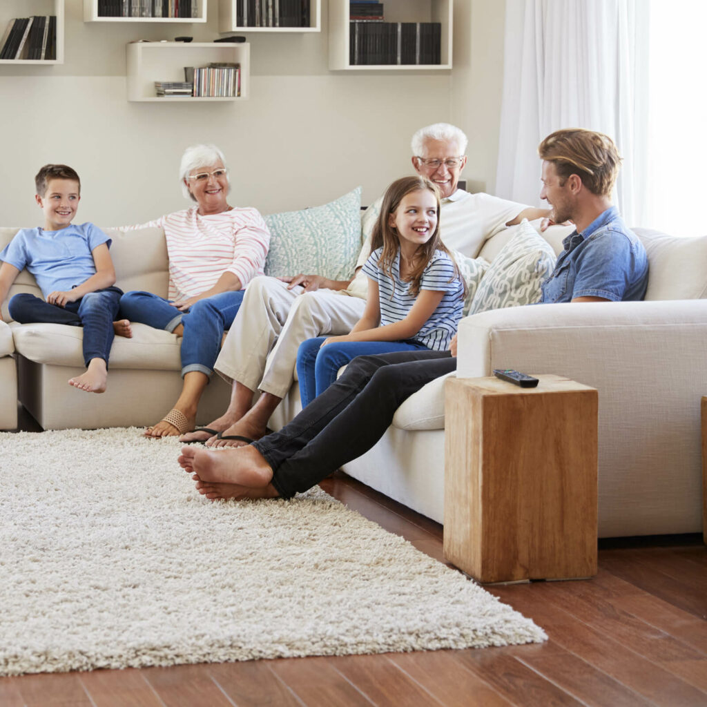 Family relaxing together in a comfortable living room with hardwood flooring | All Floors Design Centre